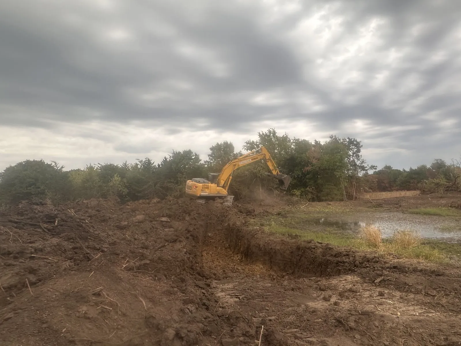 An excavator digging on an Oklahoma job site