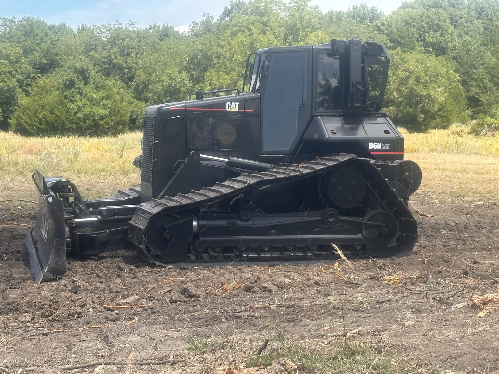 Cat D6 dozer parked on cleared ground
