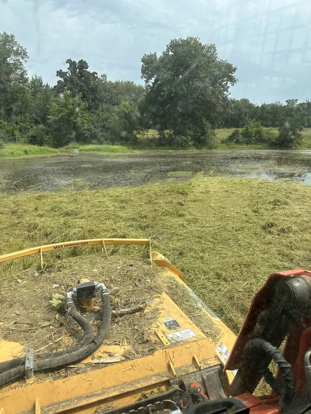 Stock pond holding water at the edge of a worked Oklahoma field