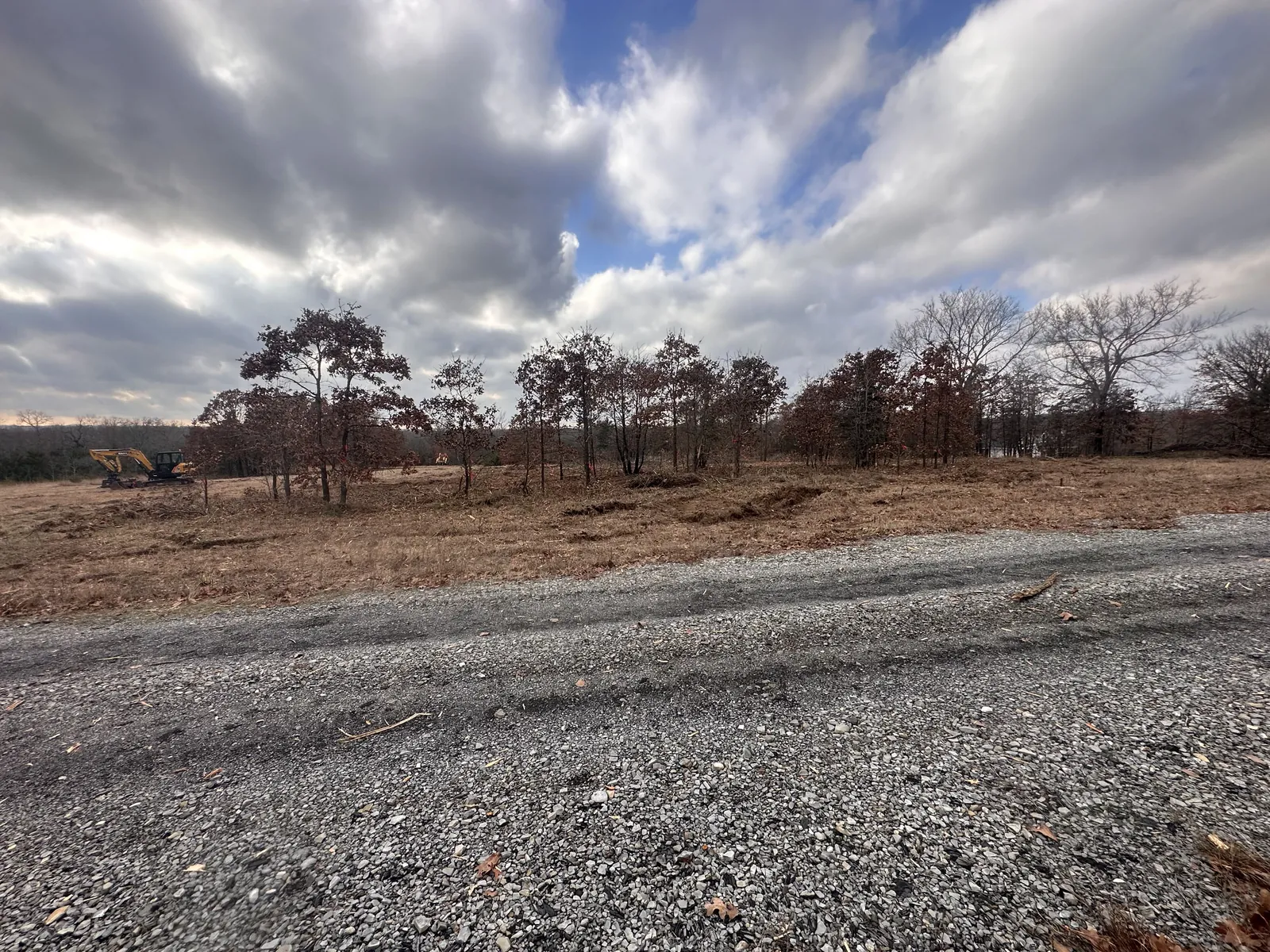 Cleared land with a new gravel drive on an Oklahoma property after land clearing